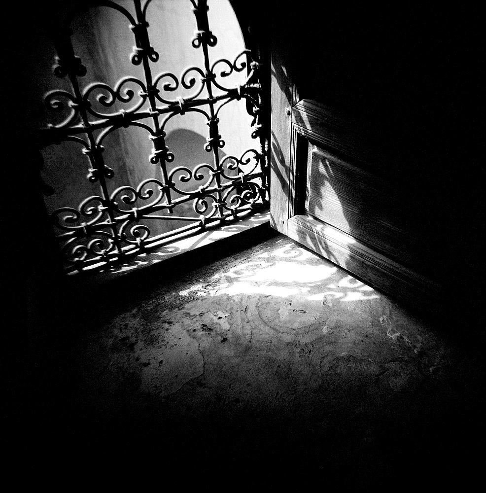 Image taken with a Holga medium format 120 film toy camera of detail of window with ornate iron grille and sunlight streaming through, Morocco, North Africa, Africa