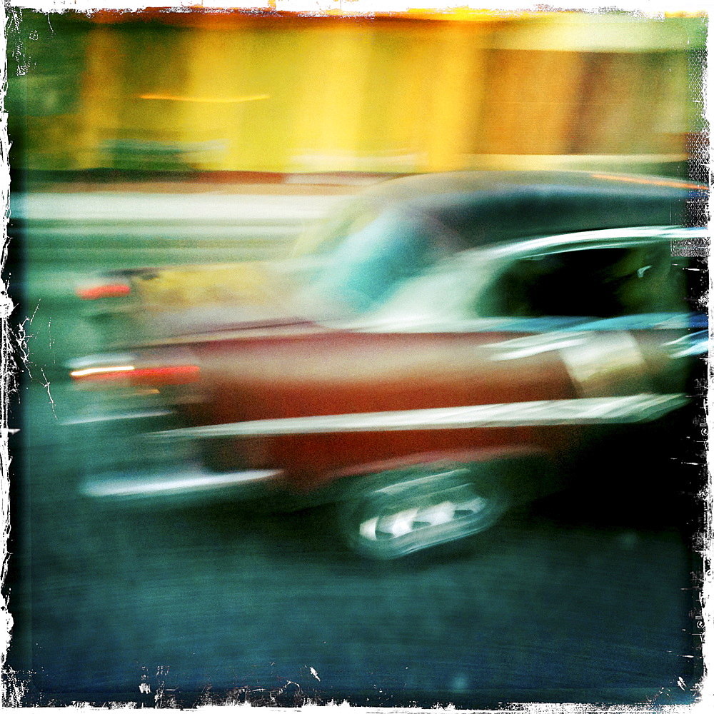 Blurred shot of passing taxi on The Malecon, Havana, Cuba, West Indies, Caribbean, Central America