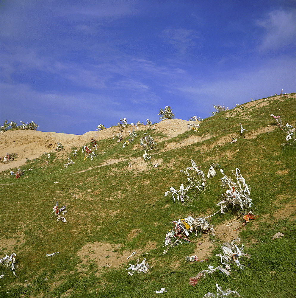 Pieces of cloth tied on hilltop by women to ask for a son, Nyrato, Uzbekistan, Central Asia, Asia