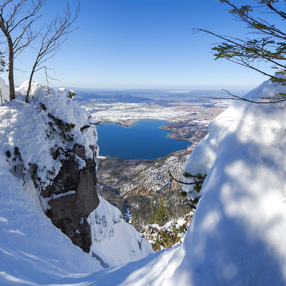 View towards lake Kochelsee and the foothills of the Alps near Munich. View from Mt. Jochberg near lake Walchensee during winter in the bavarian Alps. Europe Germany, Bavaria