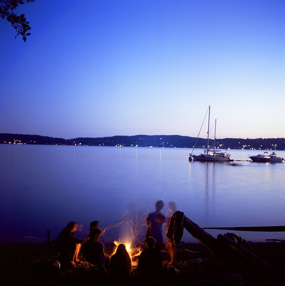 Friends around beach fire, Blake Island, Puget Sound, Washington State, United States of America (U.S.A.), North America