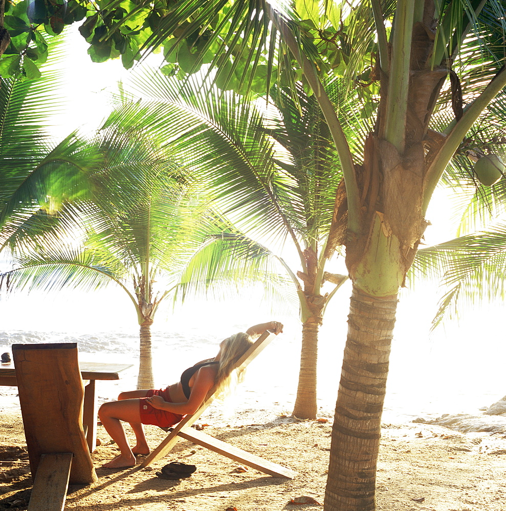 Young woman relaxes on Avellans Beach, Costa Rica, Central America