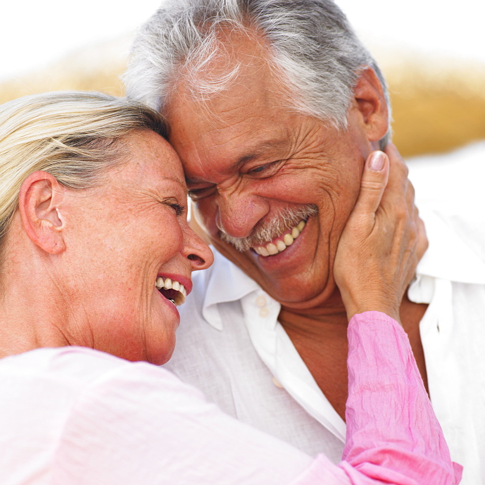 senior couple embracing outdoors, close-up