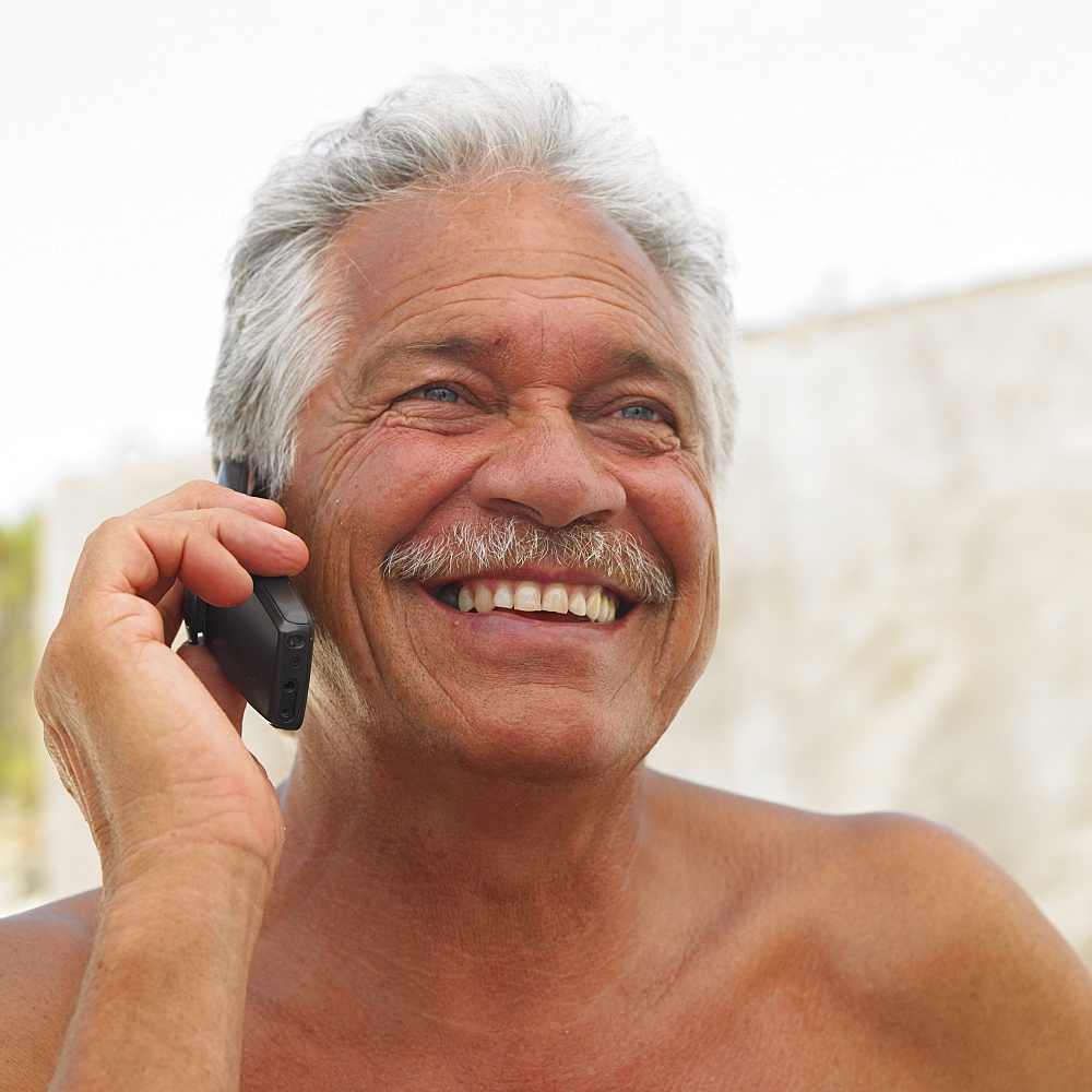 Senior man on mobile phone outdoors