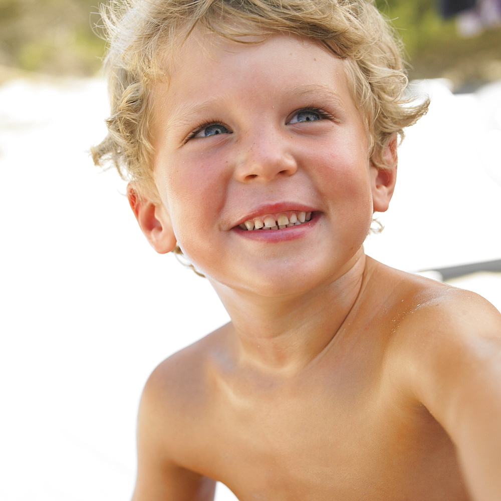 Boy (6-8) on beach