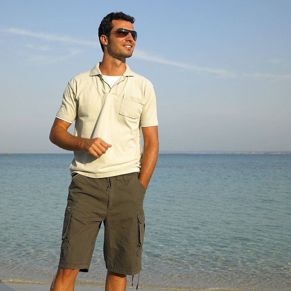 Man on beach wearing sunglasses