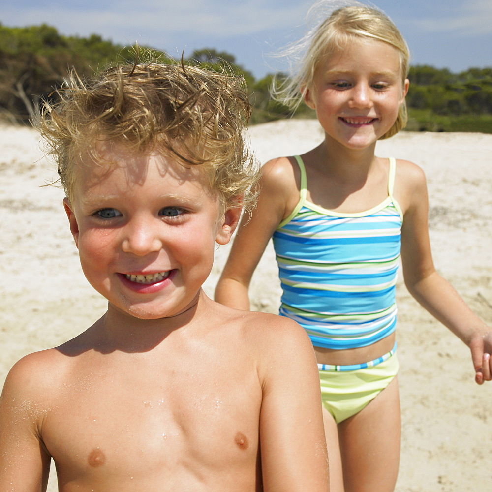 Boy and girl (6-8) on beach