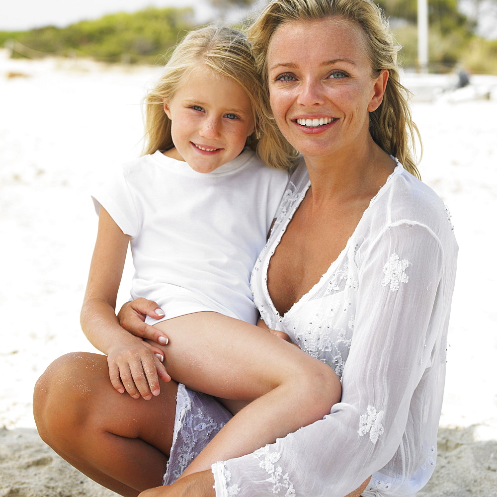 Mother and daughter (6-8) on beach