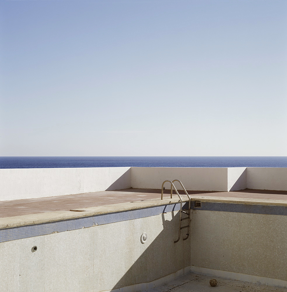 Abandoned empty swimming pool next to sea, Ibiza, Spain, Europe