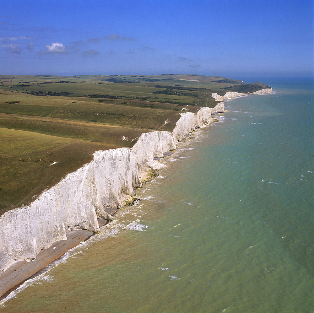 Aerial image of the chalk cliffs of the Seven Sisters, with Belle Tout lighthouse and Beachy Head in the distance, East Sussex, England, United Kingdom, Europe