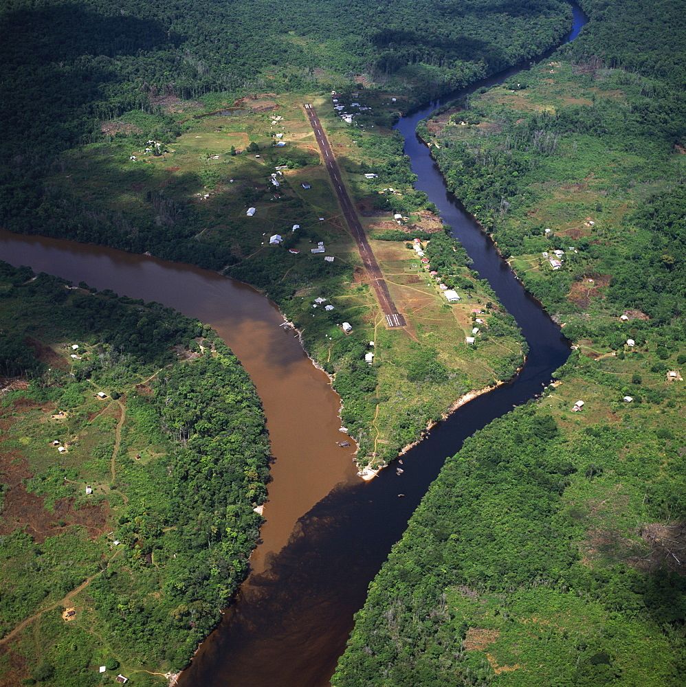 Aerial image of Kamarang Mouth Station and airstrip at the confluence of the unpolluted Kamarang River with the mined and heavily polluted Upper Mazaruni River in March 2005, Guyana, South America