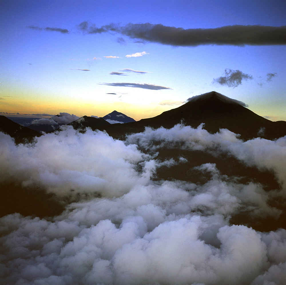 Aerial view of Mount Karisimbi, a dormant volcano in the Virunga Mountains on the border between Rwanda and the Democratic Republic of Congo (DRC), flanked by Mount Mikeno to the north, Mount Bisoke to the east and Mount Nyiragongo to the west, Great Rift Valley, Africa