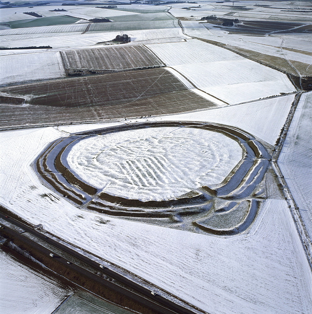 Aerial image of Yarnbury Castle, a hill fort, in snow, Wiltshire, England, United Kingdom, Europe