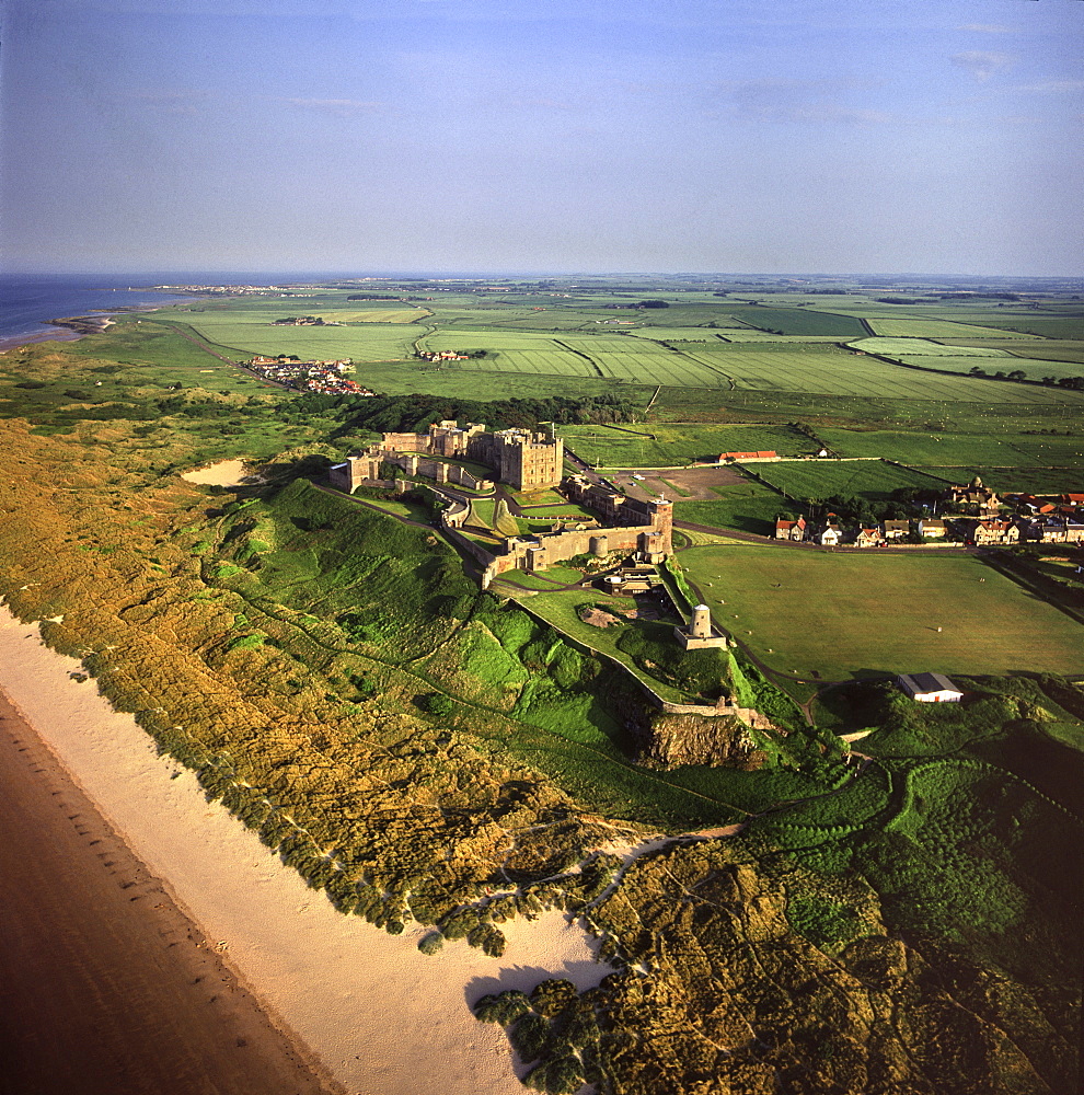 Aerial image of Bamburgh Castle, a Norman castle built on a basalt outcrop on the coast, Bamburgh, Northumberland, England, United Kingdom, Europe