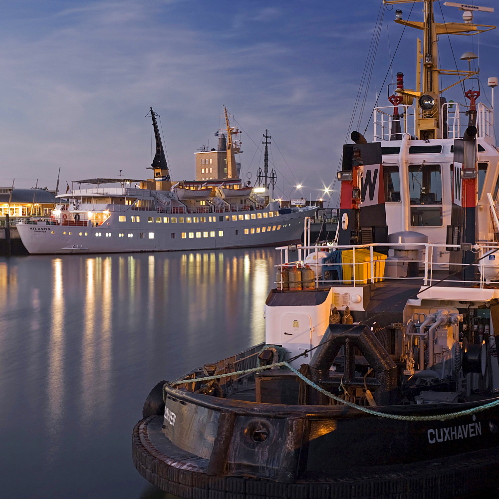 Cruise liner, Atlantis, and tugboat, Taucher O. Wulf 3, at Alte Liebe pier in Cuxhaven, Lower Saxony, Germany, Europe