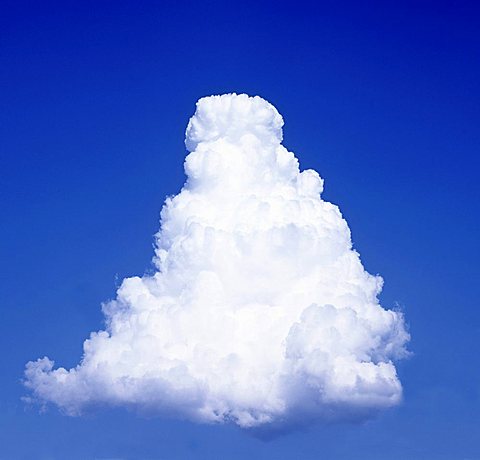 Pyramid-shaped cumulus cloud in a blue sky