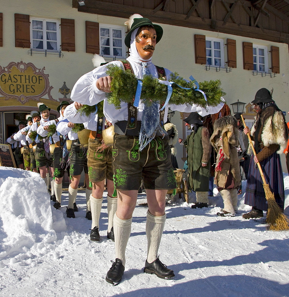 "Schellenruehrer" bell ringers in front of the Gasthof Grieskirchen inn, carnival, Mittenwald, Werdenfels, Upper Bavaria, Bavaria, Germany, Europe