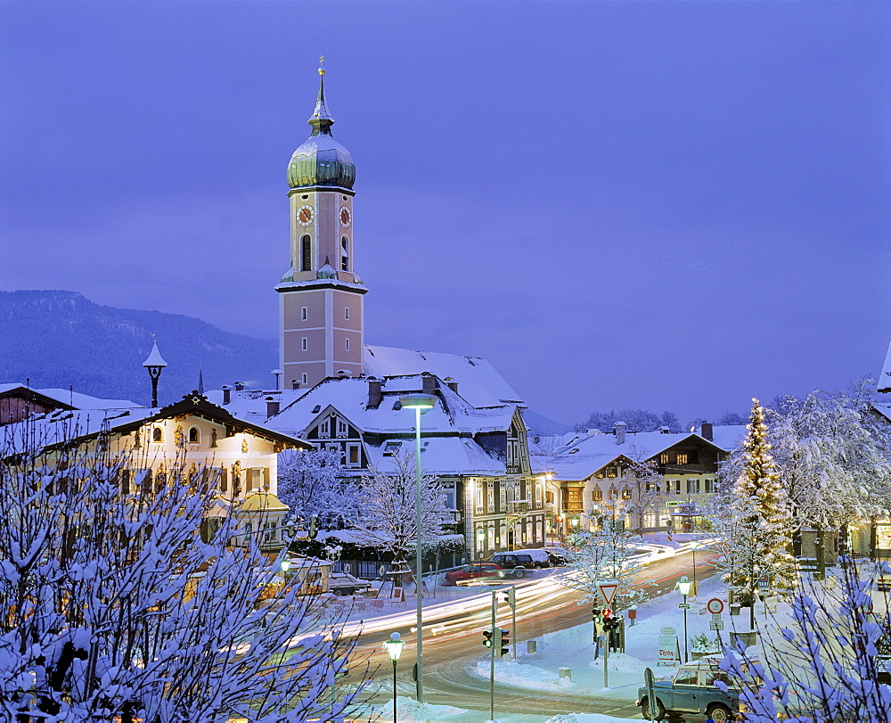 Church in Garmisch-Partenkirchen at dusk, Christmastime, Christmas tree in town square, Upper Bavaria, Bavaria, Germany, Europe