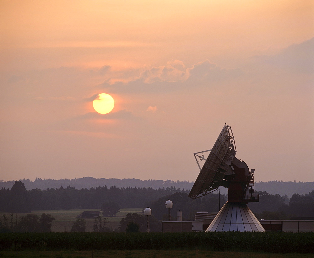 Sun at dusk, antennas of the ground communication station Raisting, Upper Bavaria, Germany