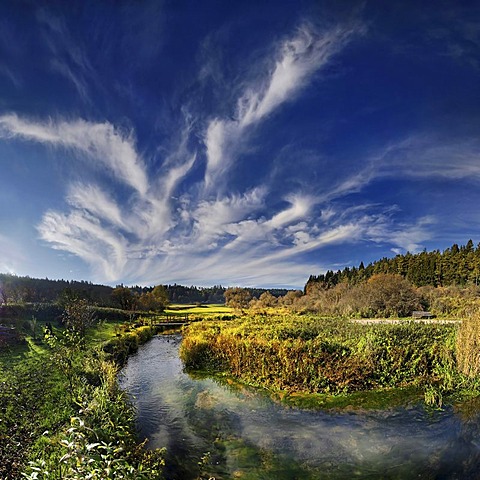 Bizarre cloudforms reflected in the idyllic little creek of Morsbach, Altmuehltal Nature Park near Emsing, Bavaria, Germany, Europe