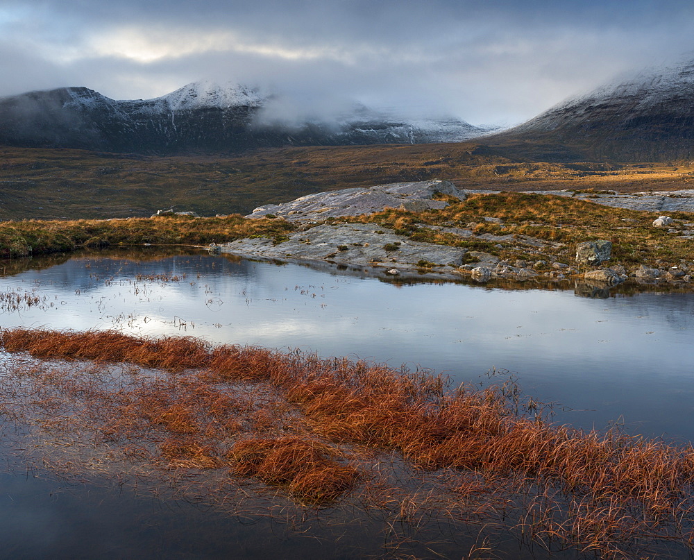 The mountain Quinag viewed across a lochan, near Inchnadamph, Sutherland, Scotland, United Kingom, Europe