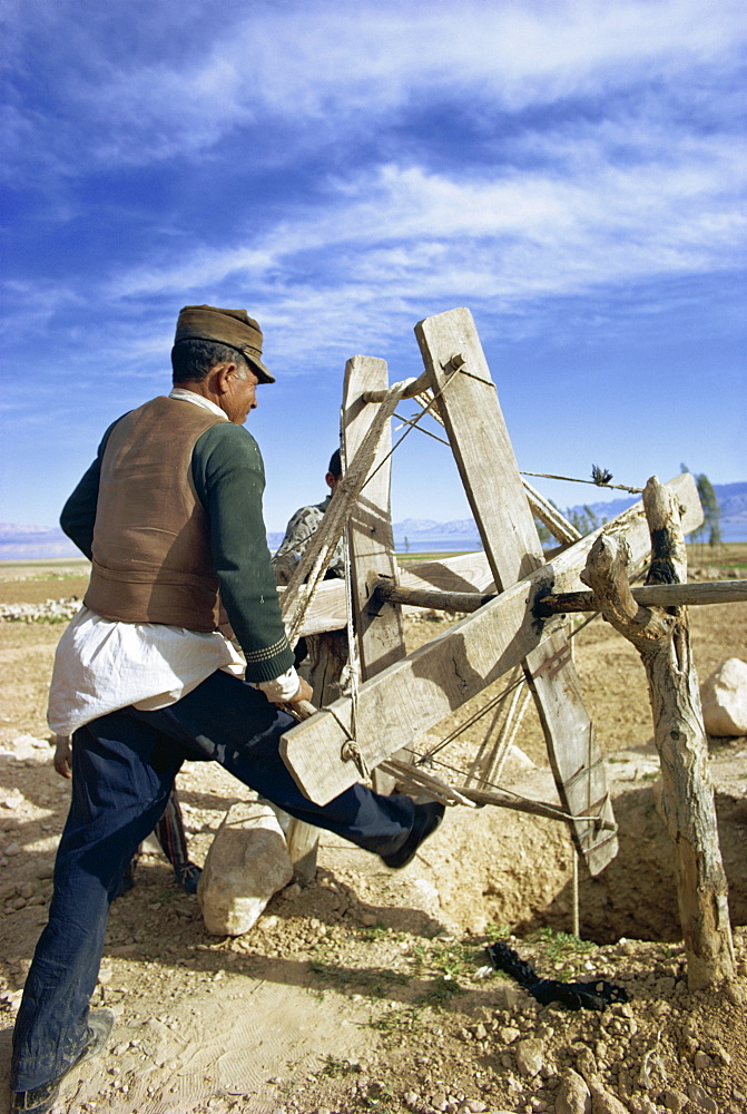 Man using a winding machine to get water from well, kanat (qanat) irrigation system, Gashgai, Iran, Middle East