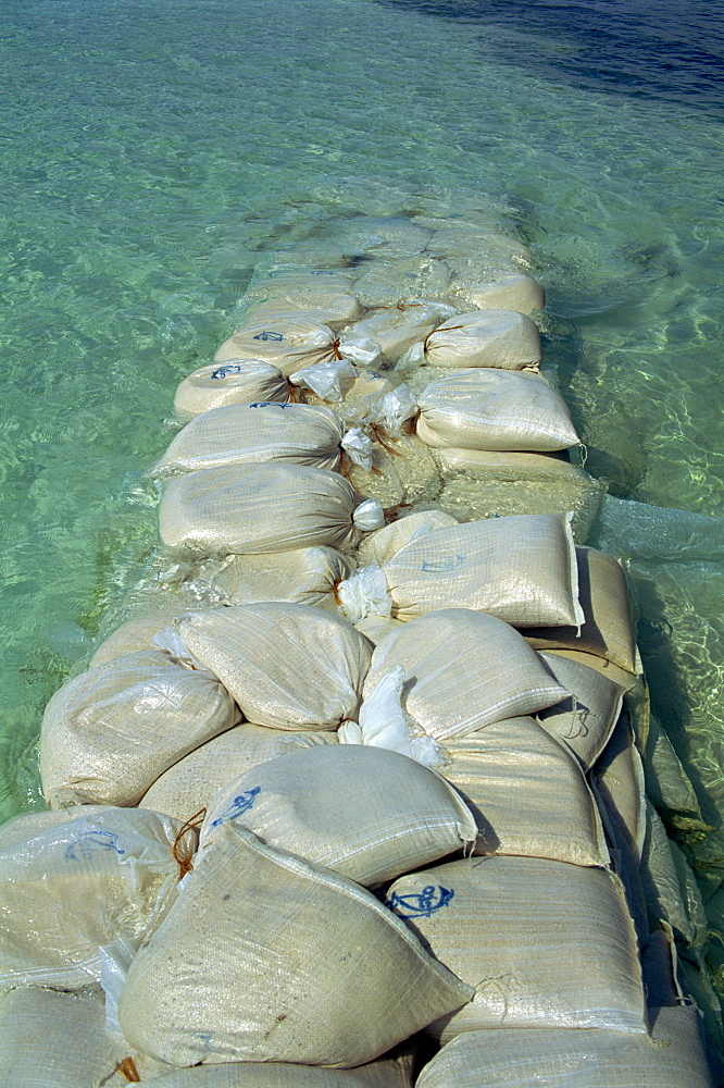 Plastic bags filled with sand as erosion control, Maldives, Indian Ocean, Asia