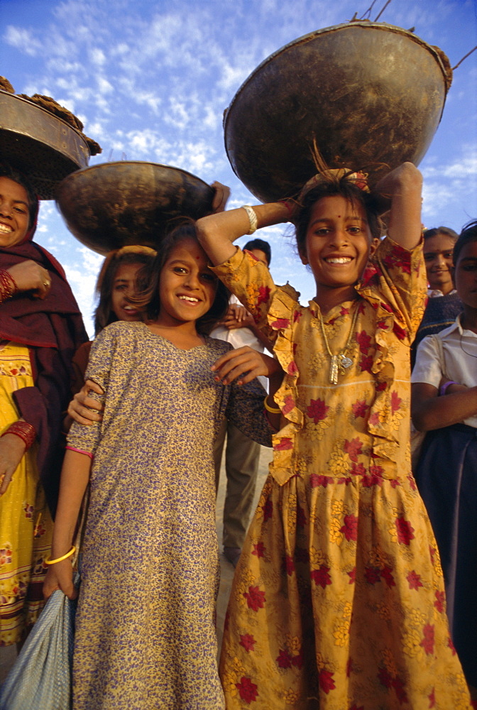 Women and children gathering dung for their cooking fires, near Khimsar, Rajasthan, India