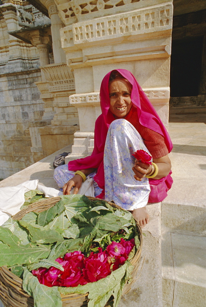 Woman selling flowers outside the Jain Temple of Chaumukha, Rajasthan, India