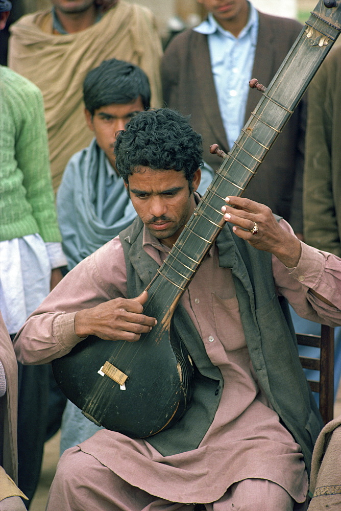 Portrait of a musician with his stringed instrument at Alipur village near Rawalpindi, Pakistan, Asia