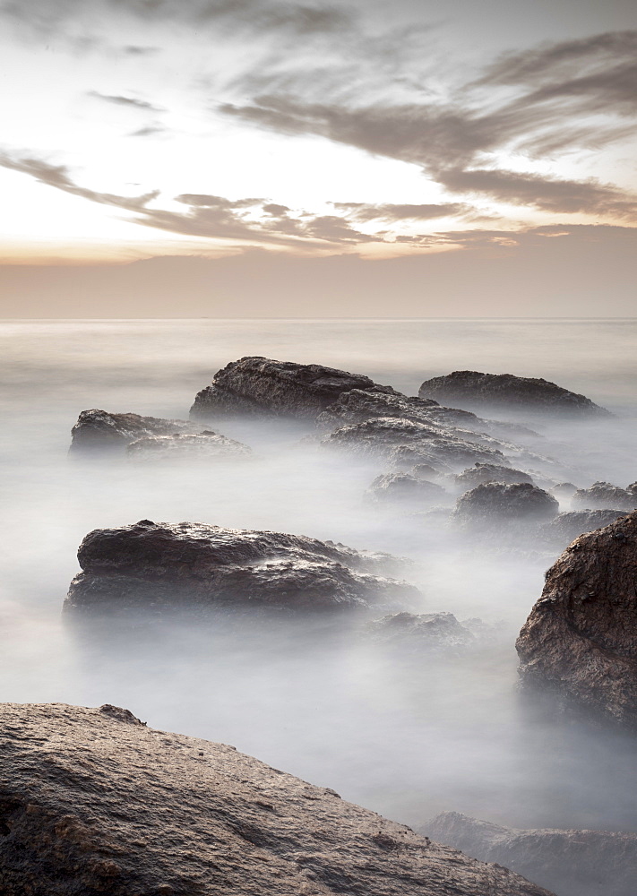 Long exposure of surf and rocks at sunrise, Tangalle, Sri Lanka, Indian Ocean, Asia 