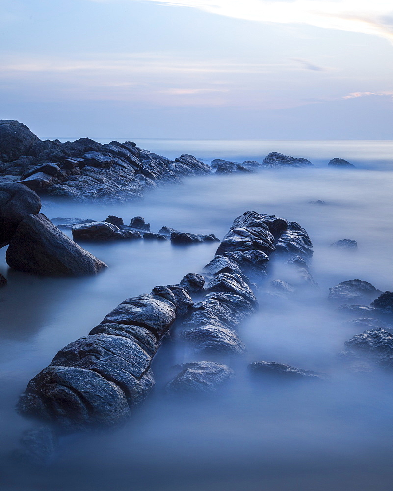 Long exposure of surf and rocks at sunrise, Tangalle, Sri Lanka, Indian Ocean, Asia 