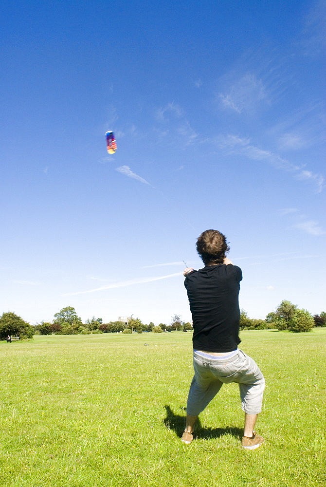 Man flying power kite on the Downs, Bristol, UK