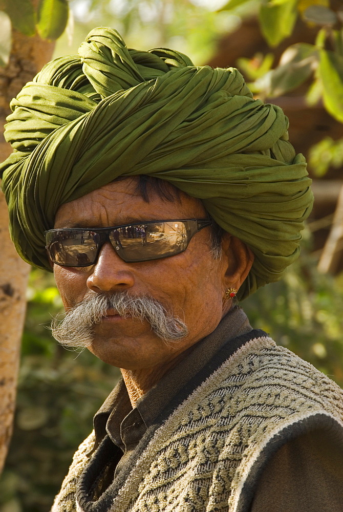 Portrait of elderly man in sunglasses and turban, Udaipur, Rajasthan, India