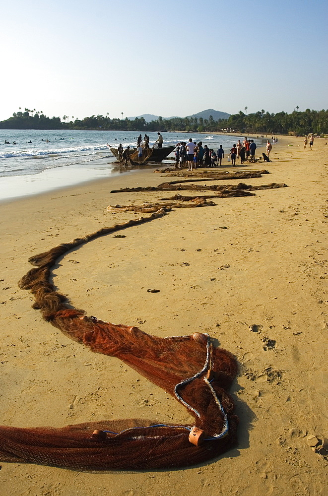 Fishing net laid out on the beach after hauling in the fish, Goa, India