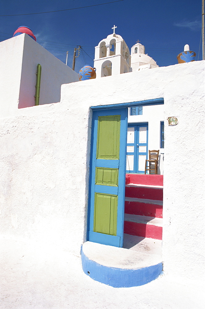 Blue and green door leading to pink steps at the entrance to a pension in Fira Town, the capital of Santorini (Thira), Cyclades Islands, Greek Islands, Greece, Europe