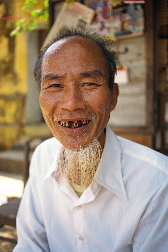 Portrait of a smiling man with a beard but few teeth in Vietnam, Indochina, Southeast Asia, Asia