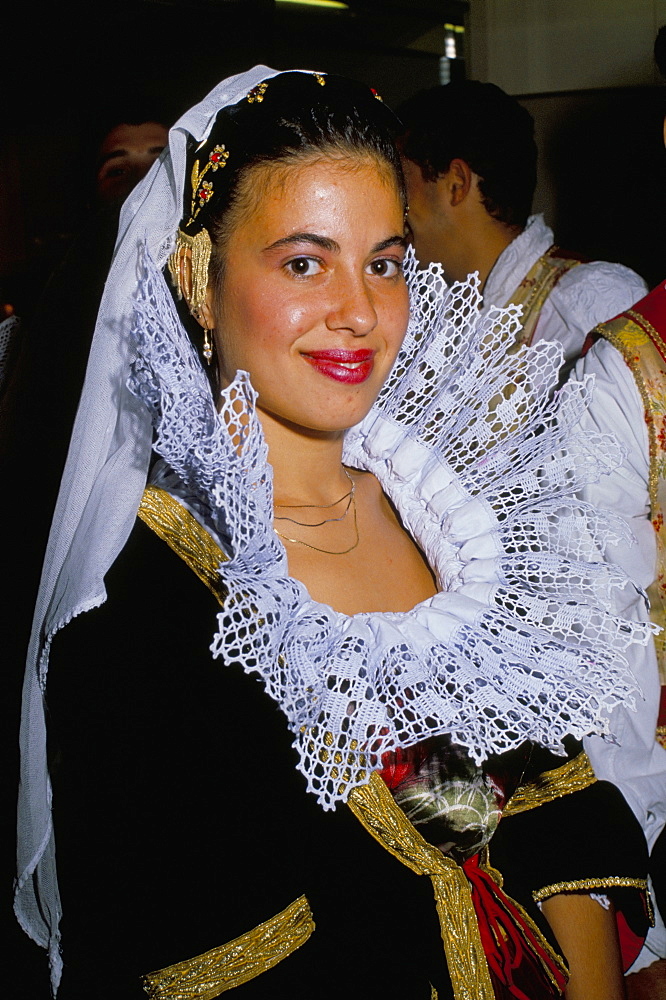 Portrait of a young woman in traditional folk costume, Cagliari, Sardinia, Italy, Europe