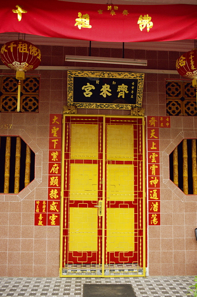 Close-up of a bright red and yellow door to a restored Chinese home on Koon Seng Road in Singapore, Southeast Asia, Asia