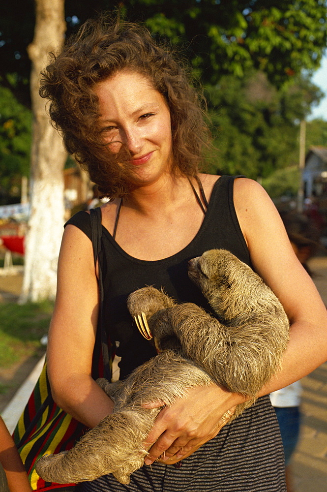 Lady cuddles three toed sloth, Alter do Chao, Amazon area, Brazil, South America