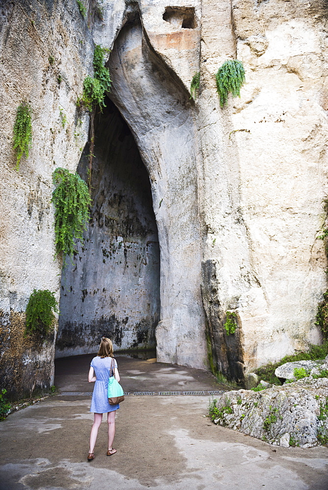 Tourist in a cave at the Quarry Garden, Archaeological Park of Syracuse, UNESCO World Heritage Site, Sicily, Italy, Europe 