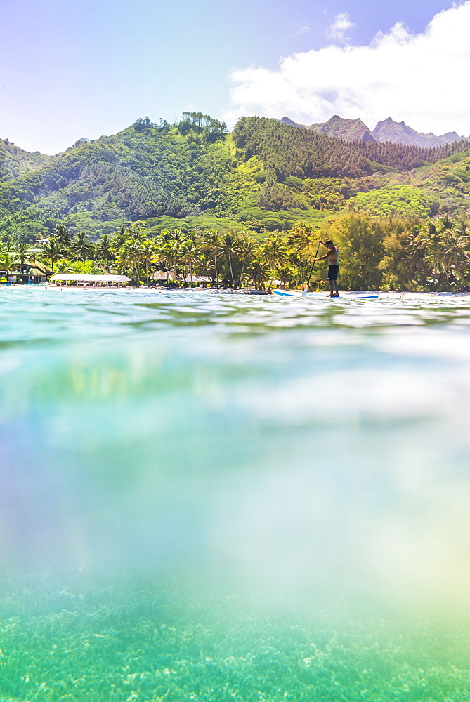 Paddleboarding in Muri Lagoon with Rarotonga in the background, Cook Islands, South Pacific, Pacific