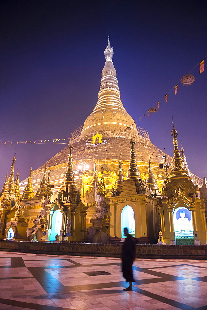 Buddhist monk at Shwedagon Pagoda (Shwedagon Zedi Daw) (Golden Pagoda) at night, Yangon (Rangoon), Myanmar (Burma), Asia