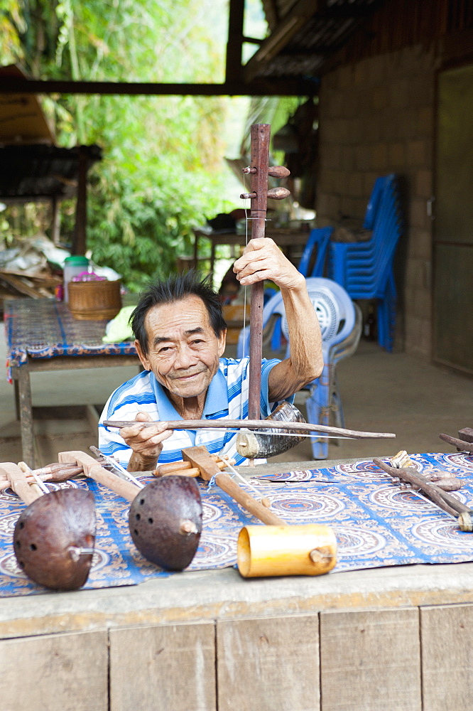 Man playing handmade musical instrument seller, Luang Prabang, Laos, Indochina, Southeast Asia, Asia