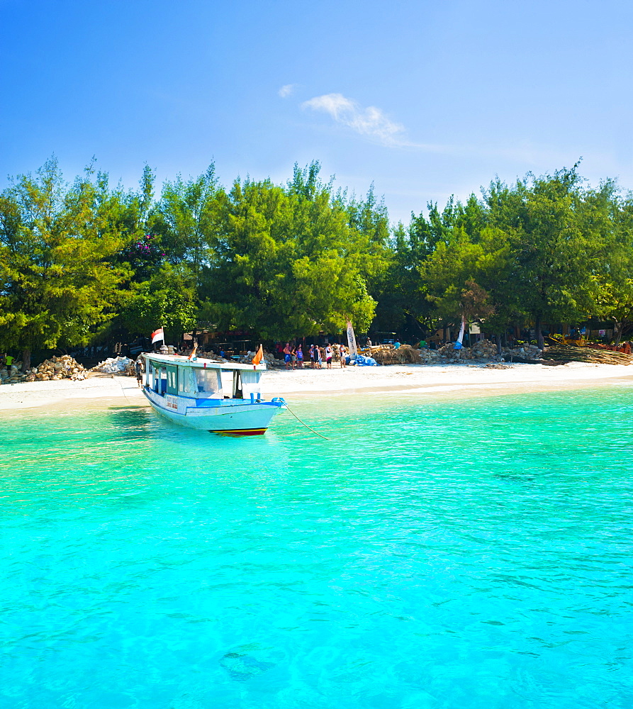 Traditional Indonesian outrigger boat in the crystal clear waters of Gili Trawangan, Gili Isles, Indonesia, Southeast Asia, Asia