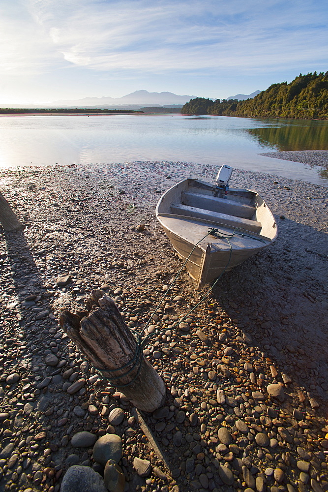 Motor boat at sunrise, Okarito Lagoon, West Coast, South Island, New Zealand, Pacific 