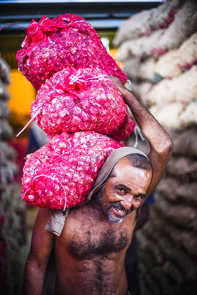 Man carrying vegetables at Dambulla vegetable and produce market in Dambulla, Central Province, Sri Lanka, Asia