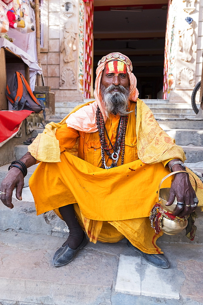 Portrait of Sadhu in orange robes in Pushkar, Rajasthan, India, Asia