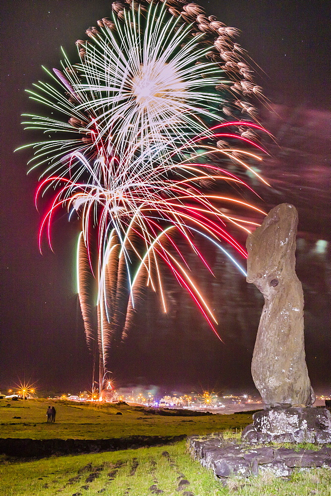 Fireworks ring in the New Year from the town of Hanga Roa over moai in the Tahai Archaeological Zone on Easter Island (Isla de Pascua) (Rapa Nui), UNESCO World Heritage Site, Chile, South America