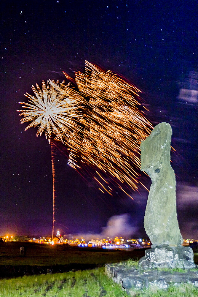 Fireworks ring in the New Year from the town of Hanga Roa over moai in the Tahai Archaeological Zone on Easter Island (Isla de Pascua) (Rapa Nui), UNESCO World Heritage Site, Chile, South America